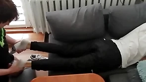 Young guy pays out his bills with his feet